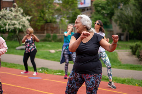 Older woman (senior, elderly) moving her body outside