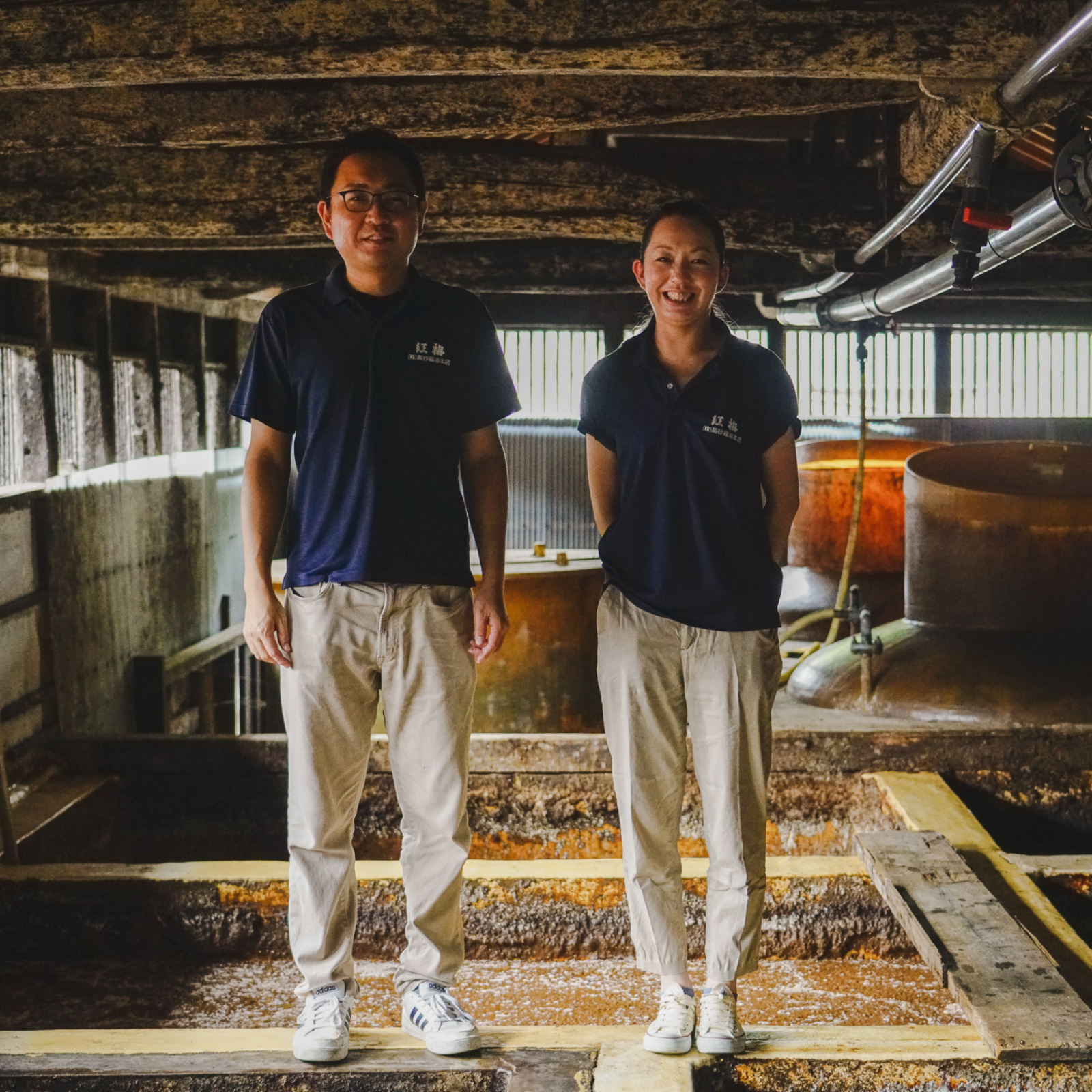 Two craftspeople standing in soy sauce brewery