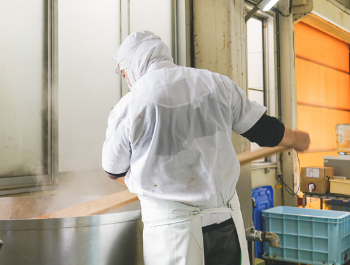 worker stirring up seaweed paste