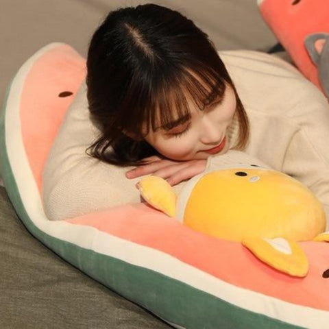 A woman laying her head on a shiba melon plushie