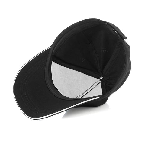a baseball cap layed back down on a table showing inside