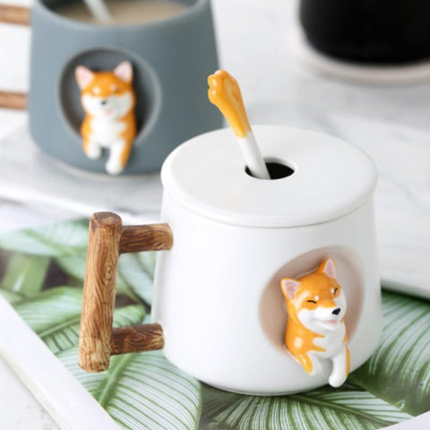 White cup in background, gray shiba inu mug in the foreground on a table