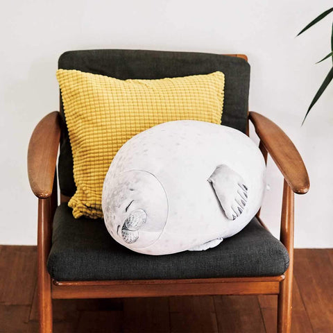 Seal pillow with eyes clothes sleeping sitting on a chair