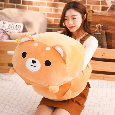 woman giving a hug to a japanese shiba plush, giving it a squeeze