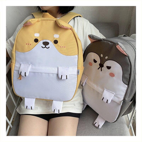 girl holding and sitting with shiba rucksacks