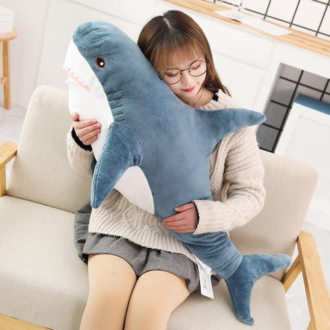 woman hugging a blue kawaii shark plush
