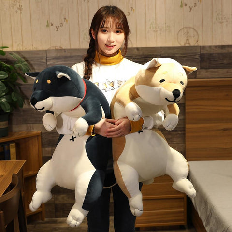 Woman standing hugging black and brown shiba dog stuffie