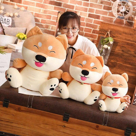 Woman with 3 shiba Inu stuffed toys in a cartoon shape