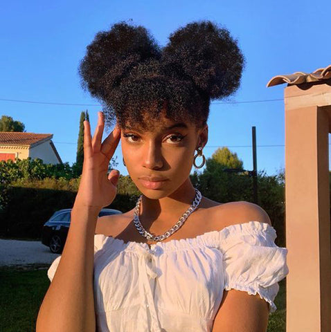 curly bangs with two buns hairstyle for black women