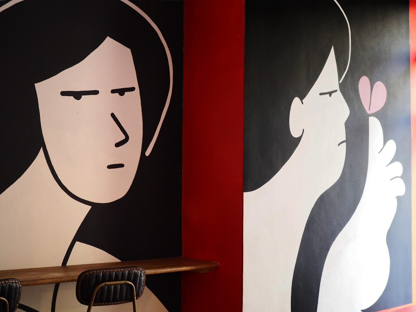 Black white and red murals of figures by artist Ana Curbelo