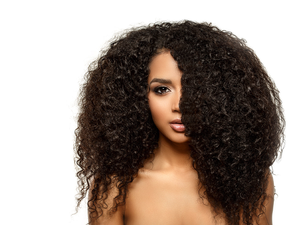  A beautiful woman of color with long, thick, natural, curly hair.