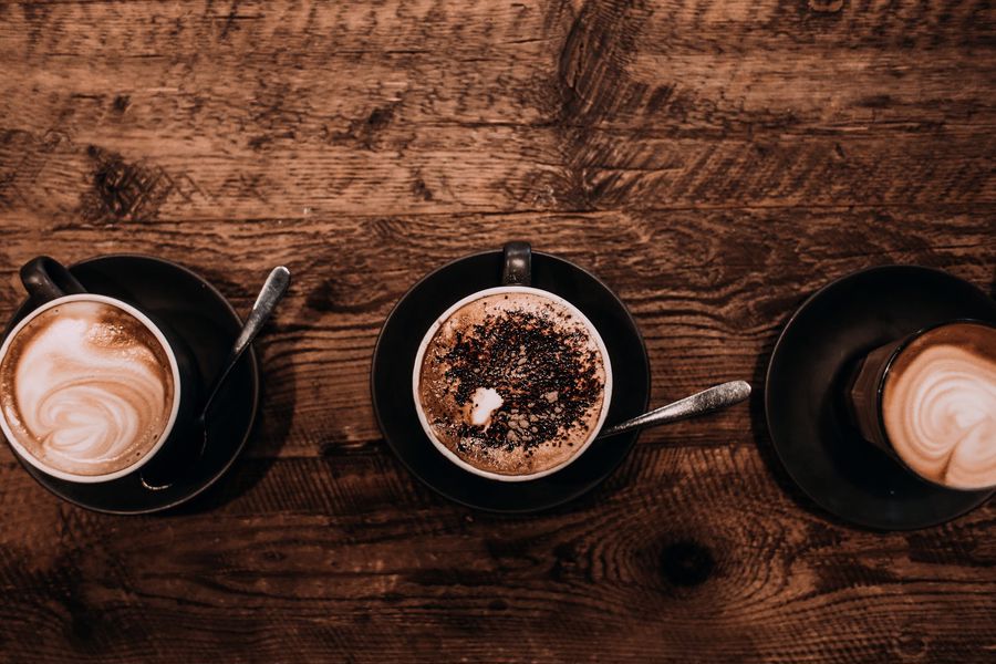 Three cups with different kinds of latte flavors