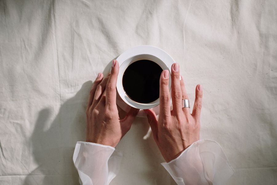 Person holding a cup of coffee