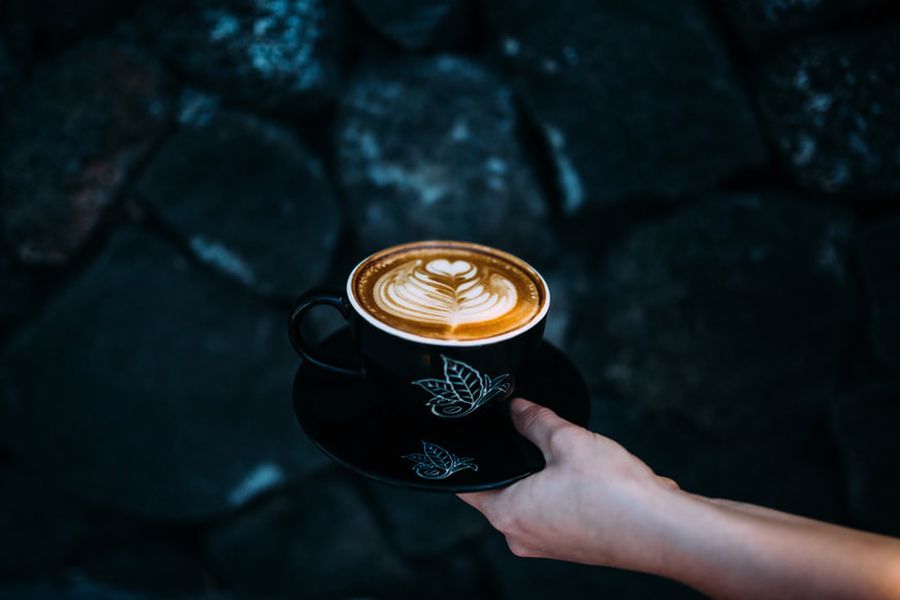 Person holding a cup of coffee