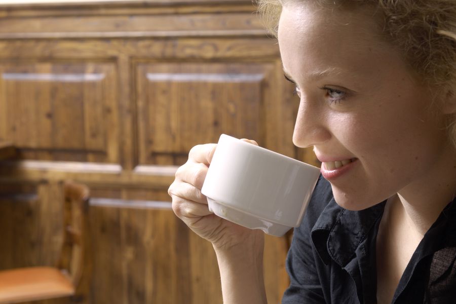 Woman enjoying a cup of Kona coffee