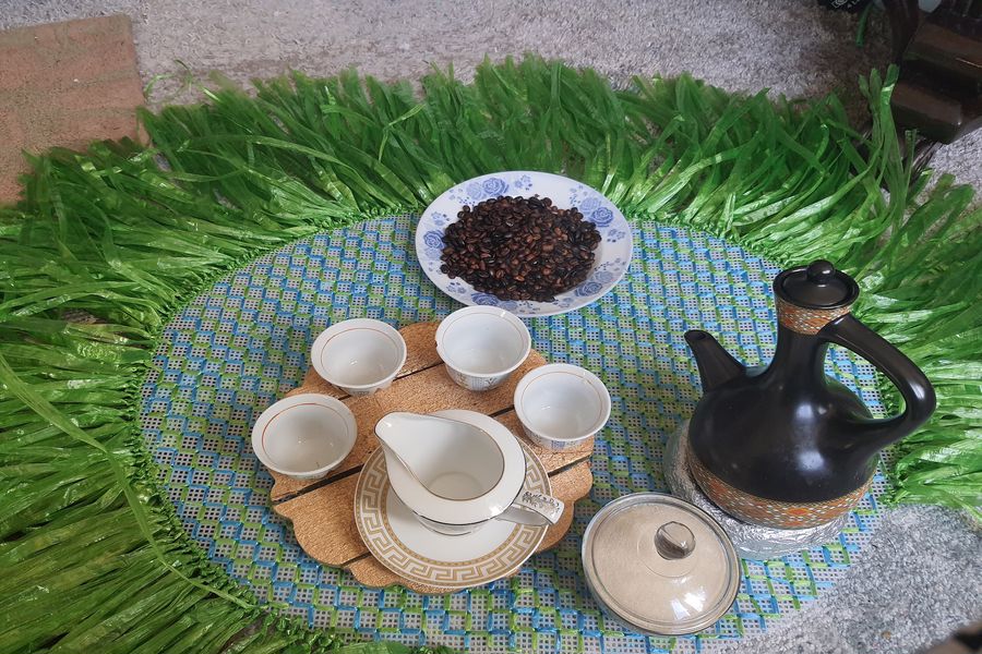 Ethiopian coffee beans with cups and traditional pot