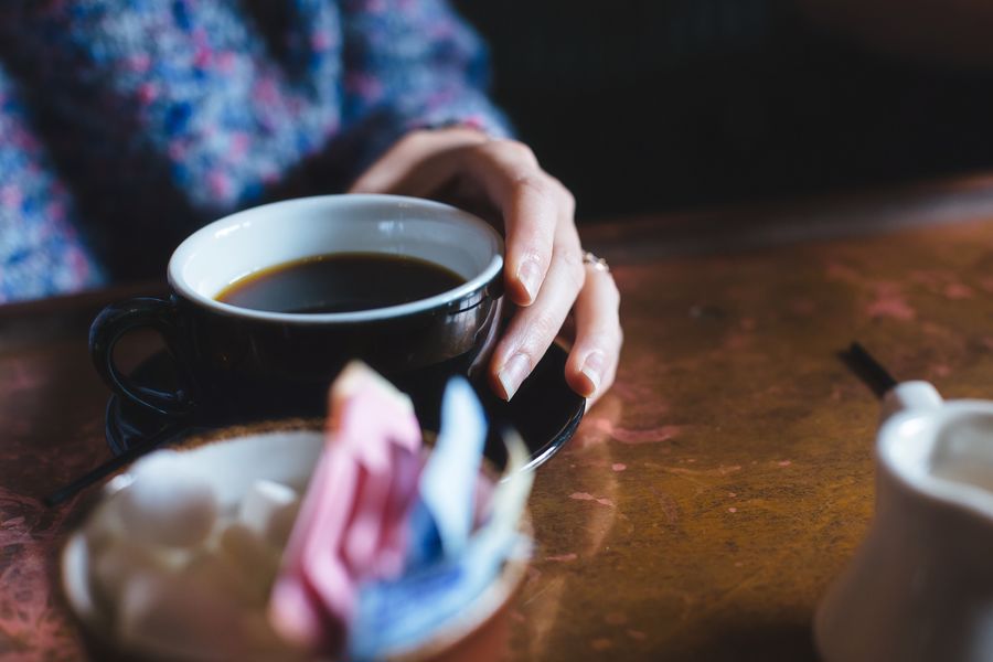 Woman holding her cup of coffee