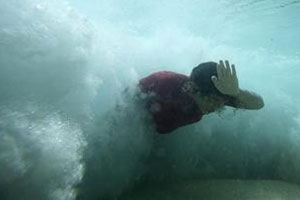 body-surfer breaking through the back of a wave 