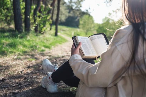 christian woman holds bible in her hands