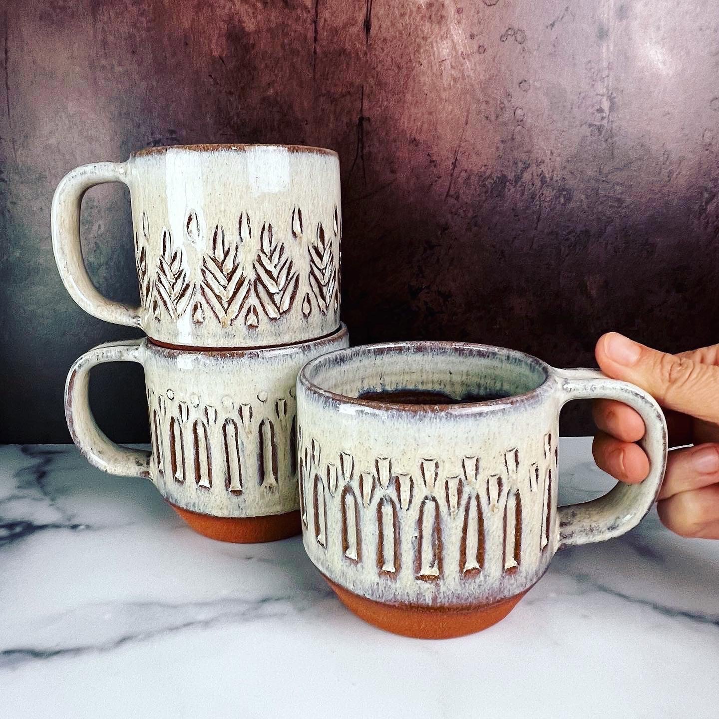 white pottery mugs