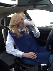 Woman Drinking Coffee in a car while wearing  an Adult Bib.