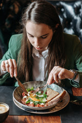 Woman eating a fancy meal in a nice business suit 