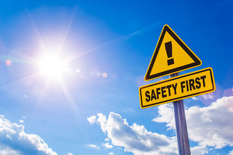 Picture of a yellow sign that says safety first with a sunny beautiful blue sky with a few white clouds in the background