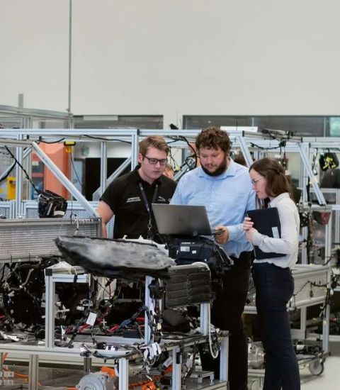 Engineers working in an industrial workspace with 3D printers