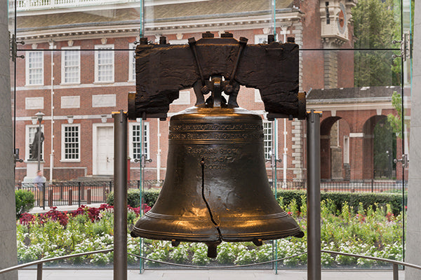 The Liberty Bell was originally made to hang in the Pennsylvania State House. Today that building is known as Independence Hall and can be seen through the window behind the bell.