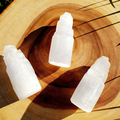 Selenite Satin Spar towers on a wooden board