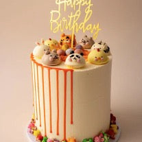 A birthday cake with many animals on top