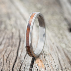 Shown here i "Eterna", a handcrafted women's stacking band featuring an ironwood inlay, upright facing left.