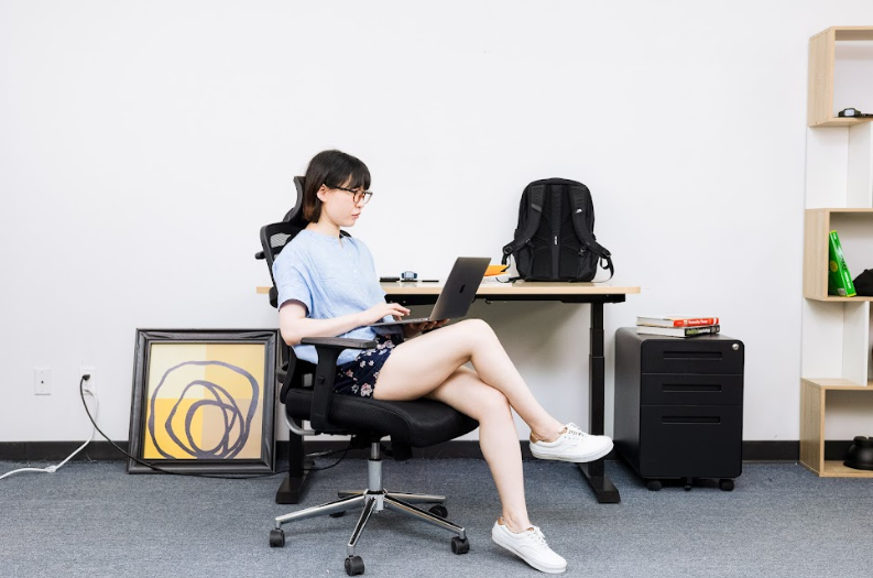 a woman sitting in an ergonomic chair