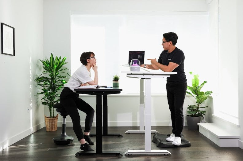 employees using a standing desk