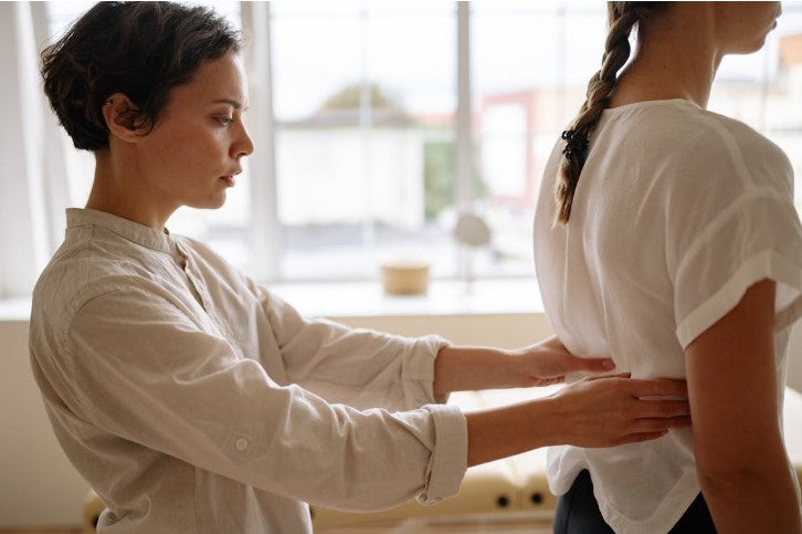 woman getting back pain treatment