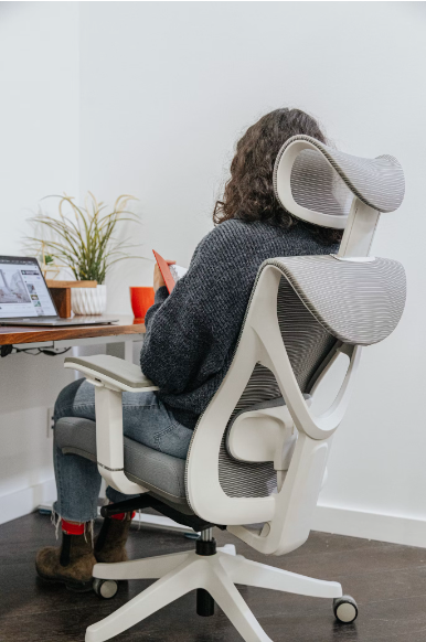 woman sitting on a chair while reading