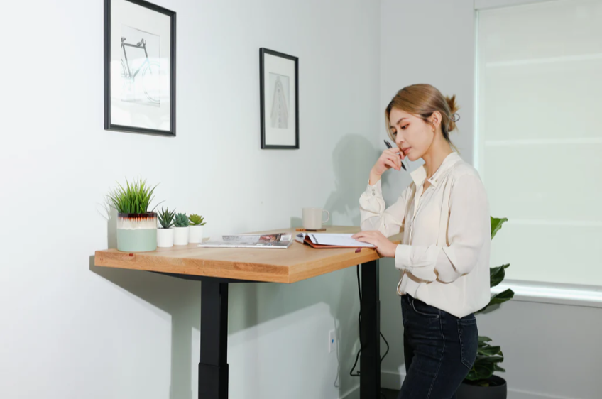 woman working on a standing desk