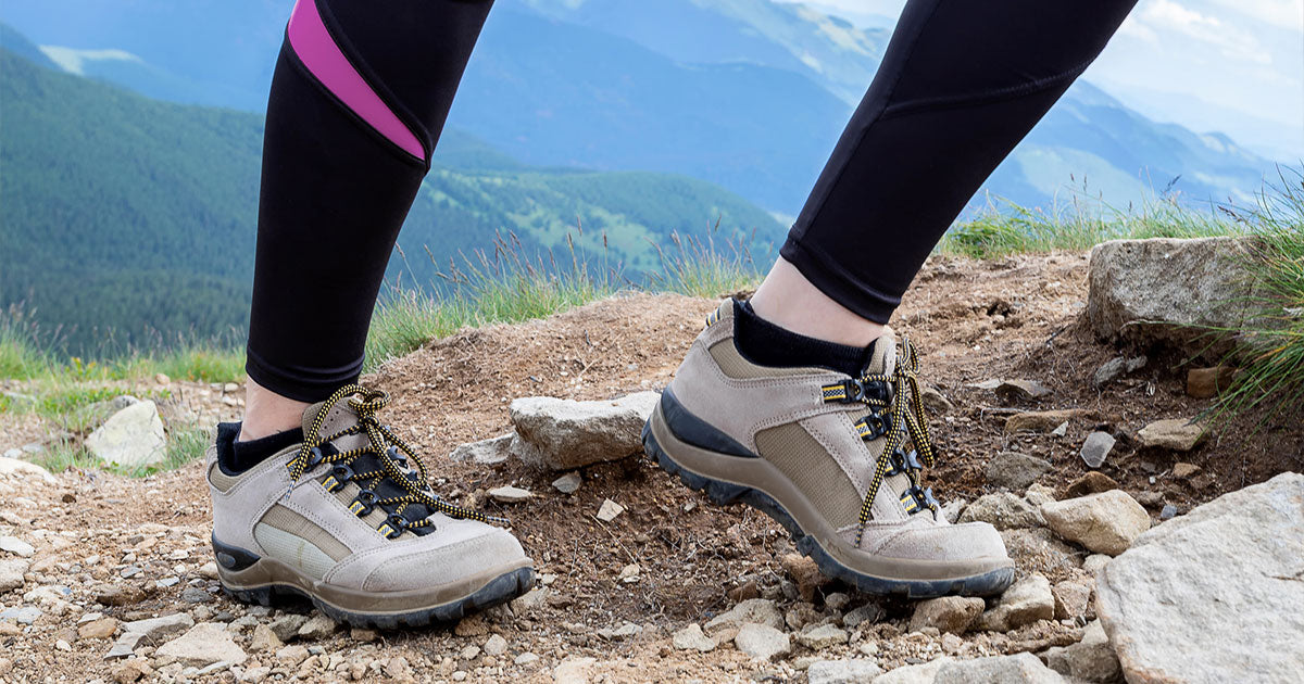 Woman on hike on mountain in hiking boots