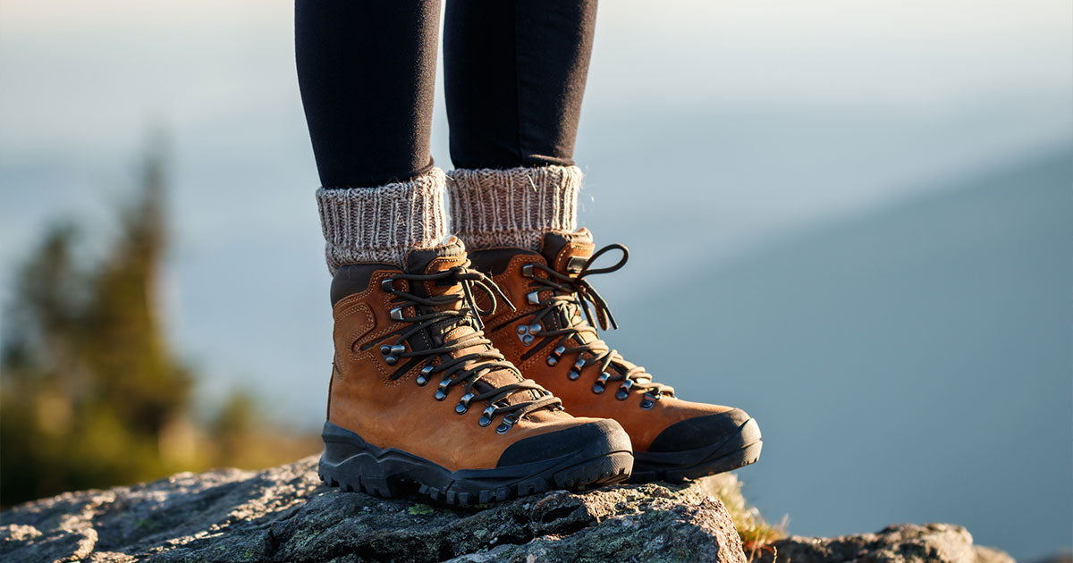 Woman wearing hiking boots on rock