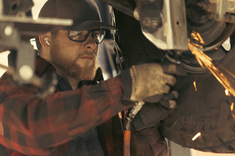Man Wearing Safety Glasses While Working on a Car
