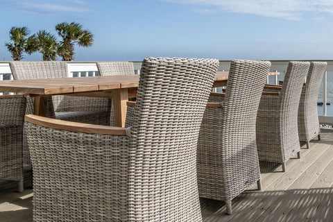 Teak dining table with wicker and teak dining chairs