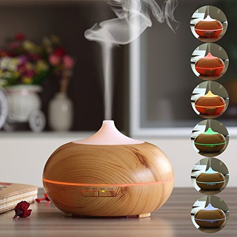 Wooden Aromatherapy Essential Oil Diffuser shooting mist into the air.
