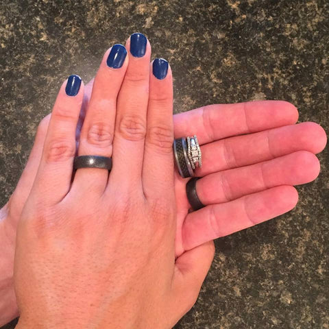 A couple of hands — one with blue fingernails and a silicone ring.  