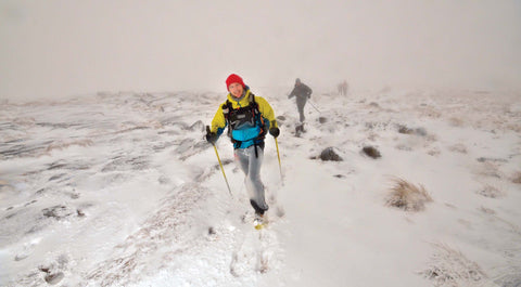 Hiking through deep snow with trekking poles