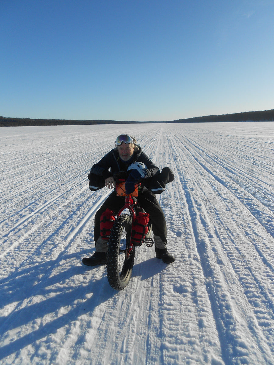 Fatbiker riding across a frozen lake