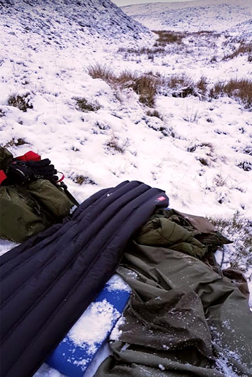 Inflatable sleeping mat on snowy ground after a bivvy