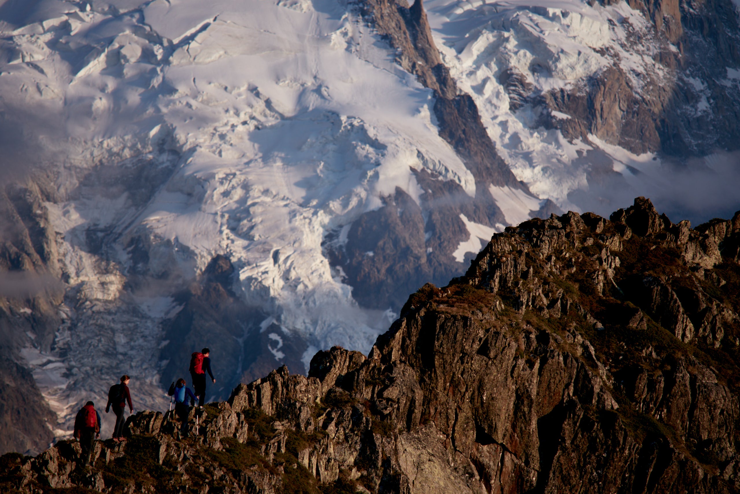 Scrambling along a knife edge ridge in the Alps