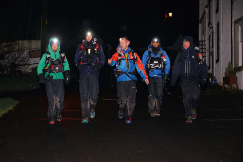Group of hikers at night wearing headtorches