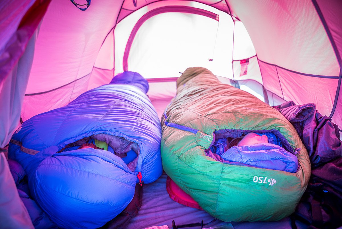 Two people sleeping in expedition sleeping bags while winter camping