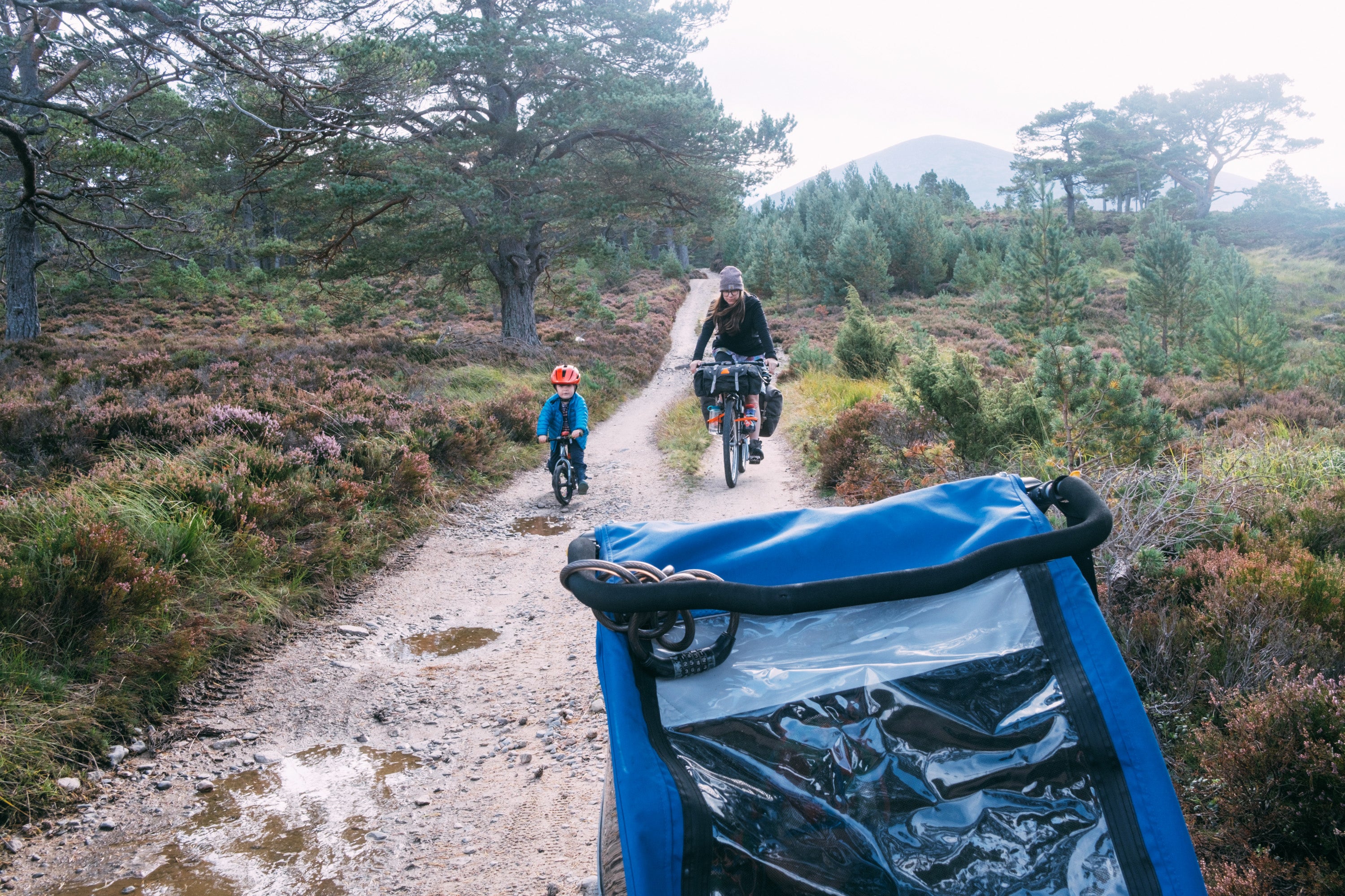 family riding their bikes down a dusty trail